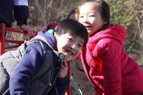 smiling asian children at the playground