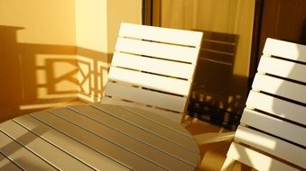 white table and two chairs on the hotel balcony