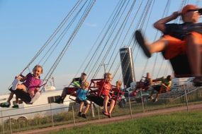 children on a quick carousel at a fair