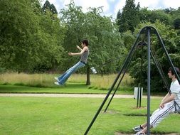 adults on the swings