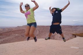 happy kids jumping in the desert