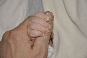 Holding baby hand