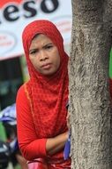 photo of muslim woman in hijab by the tree