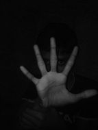 black and white photo of a hand in the dark