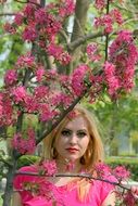 bright blonde in a pink flowered garden