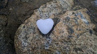 blue heart lies on a stone