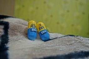 toy minions lie in bed