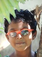 boy in sunglasses with red frames