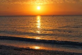 view from the beach at orange sunset