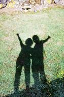 Shadows of two kids on grass