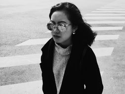 young woman in sunglasses in black and white