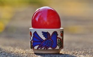 red shiny egg in a bright stand