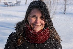 Smiling girl in the snow in winter