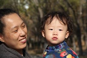 happy mom with baby in the park