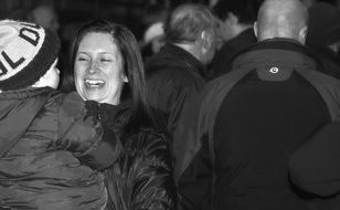 Black and white photo of the smiling mother with the child