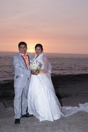 beautiful newlyweds at sunset