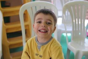 Smiling boy in the yellow dress