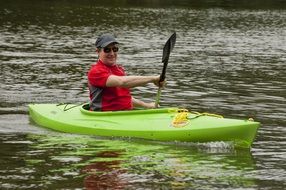 man in a bright green boat