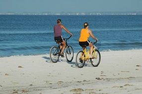 loving couple is biking on the seashore