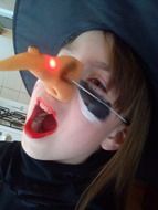 girl in witch costume for halloween