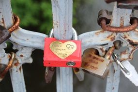 red castle with a heart on the fence of the bridge