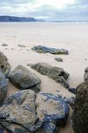 sandy coast in large stones in Cornwall