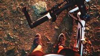 man stands near a bicycle