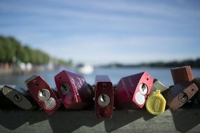 row of Love Locks on fence at water