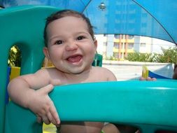 little kid on the playground in the pool