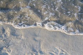 Close-up of foam of surf of tropical beach