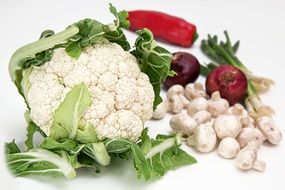 cauliflower, champignons, red onions, and peppers on the table