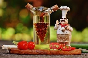 chef's figure near a bottle of vinegar