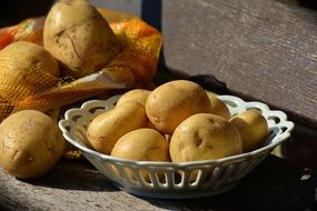 Unpeeled Raw Potatoes on wooden table