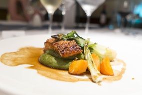 Delicious meal made of fried salmon with grilled vegetables