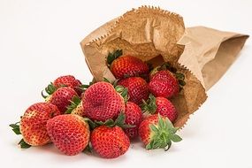 Fresh delicious red strawberries in the brown paper packet