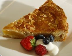 apple pie served with berries and ice cream