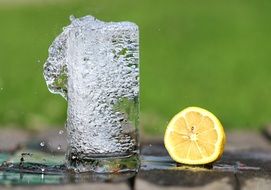half a lemon near a glass of water