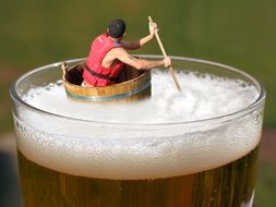 figure of a man floating in a beer glass