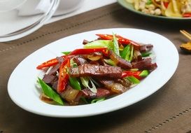 salad with bacon and pepper on a white plate