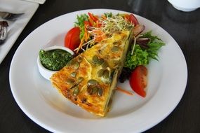 piece of Pumpkin Cake and vegetables on plate