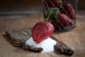Ripe strawberry lies in a sugar
