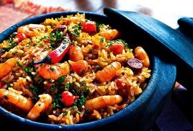shrimp with rice and seasonings in a cauldron