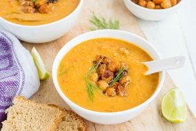 Orange healthy tasty pumpkin soup in the white bowl