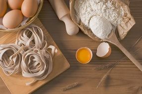 noodles, eggs and flour on the table