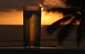 Glass of cold soda at the sunset