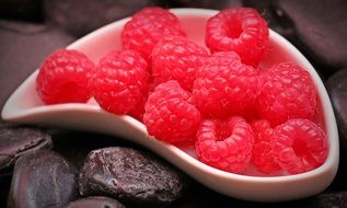 raspberries on a white dessert plate