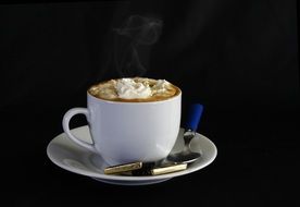 coffee with foam and sweets in a saucer