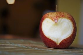 closeup photo of red Apple with Heart curving