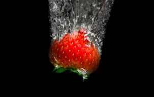 Red healthy sweet strawberry in the water