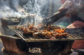 Bbq Barbecue meat on Grill with smoke